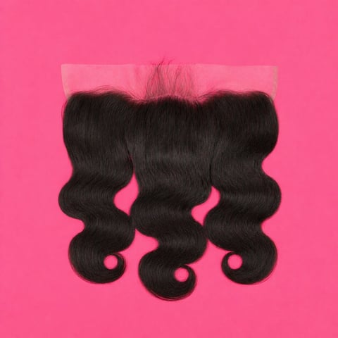 Black wavy hair extension piece on bright pink background