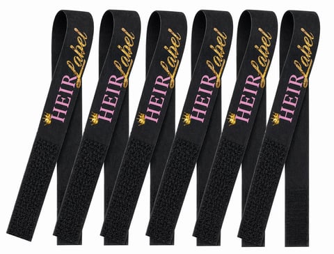 Six black hair straightening clips with HER+Dated gold and purple branding arranged in a row