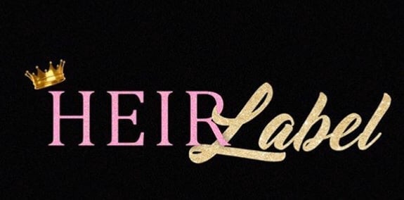 Heir Label logo featuring pink and gold text with a gold crown icon on black background